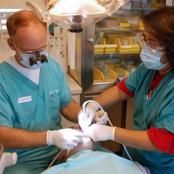 Dos professionals realitzen una higiene dental professional